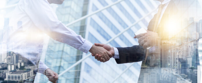 Business partnership meeting concept. Businessmen making handsha