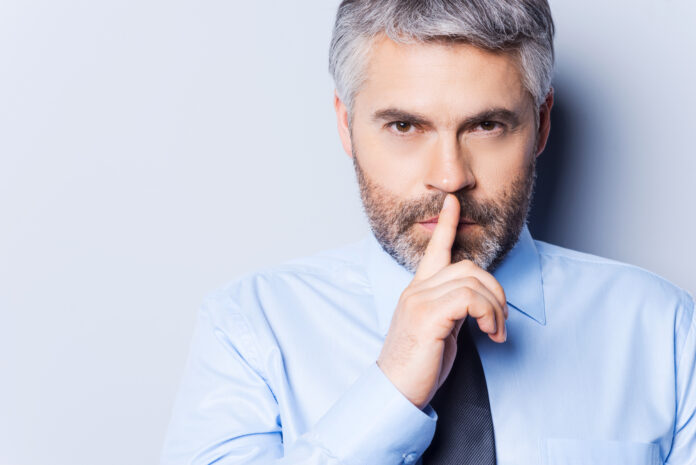 Keep my secret! Confident mature man in white shirt and tie look