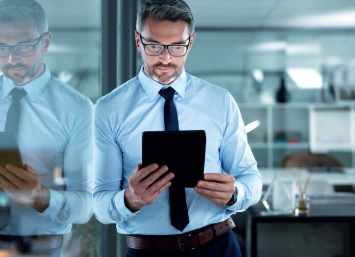 Reading email, corporate and a businessman with a tablet for communication, app or legal research. Digital, internet and a mature lawyer with technology for connection, online work or report