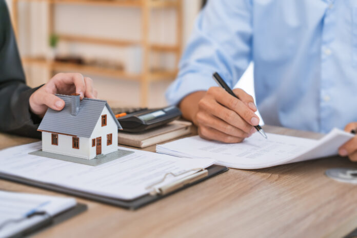 Real estate agent broker and customer with loan or insurance contract documents